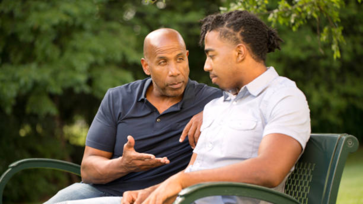 Father mentoring and giving advice to a younger man.